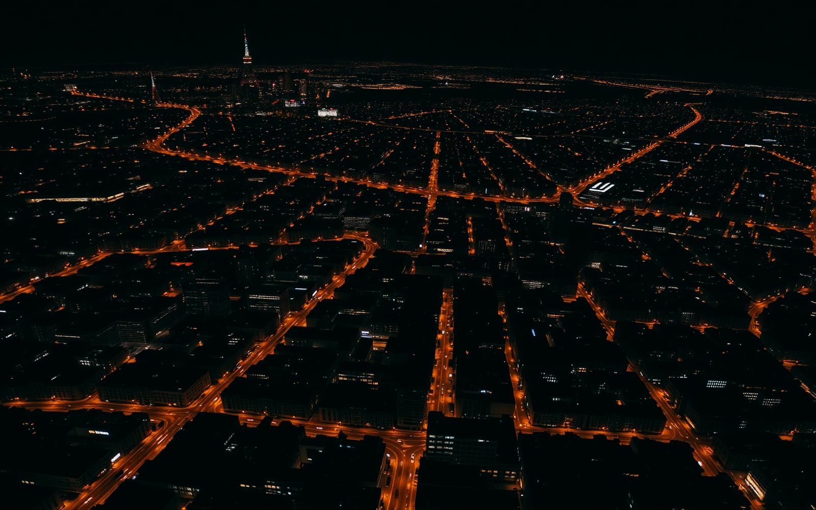 Aerial night view of a dense city grid